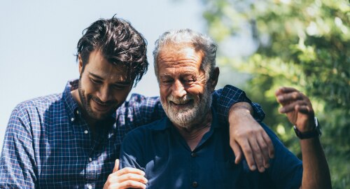 Younger man with his hand around older mans shoulders