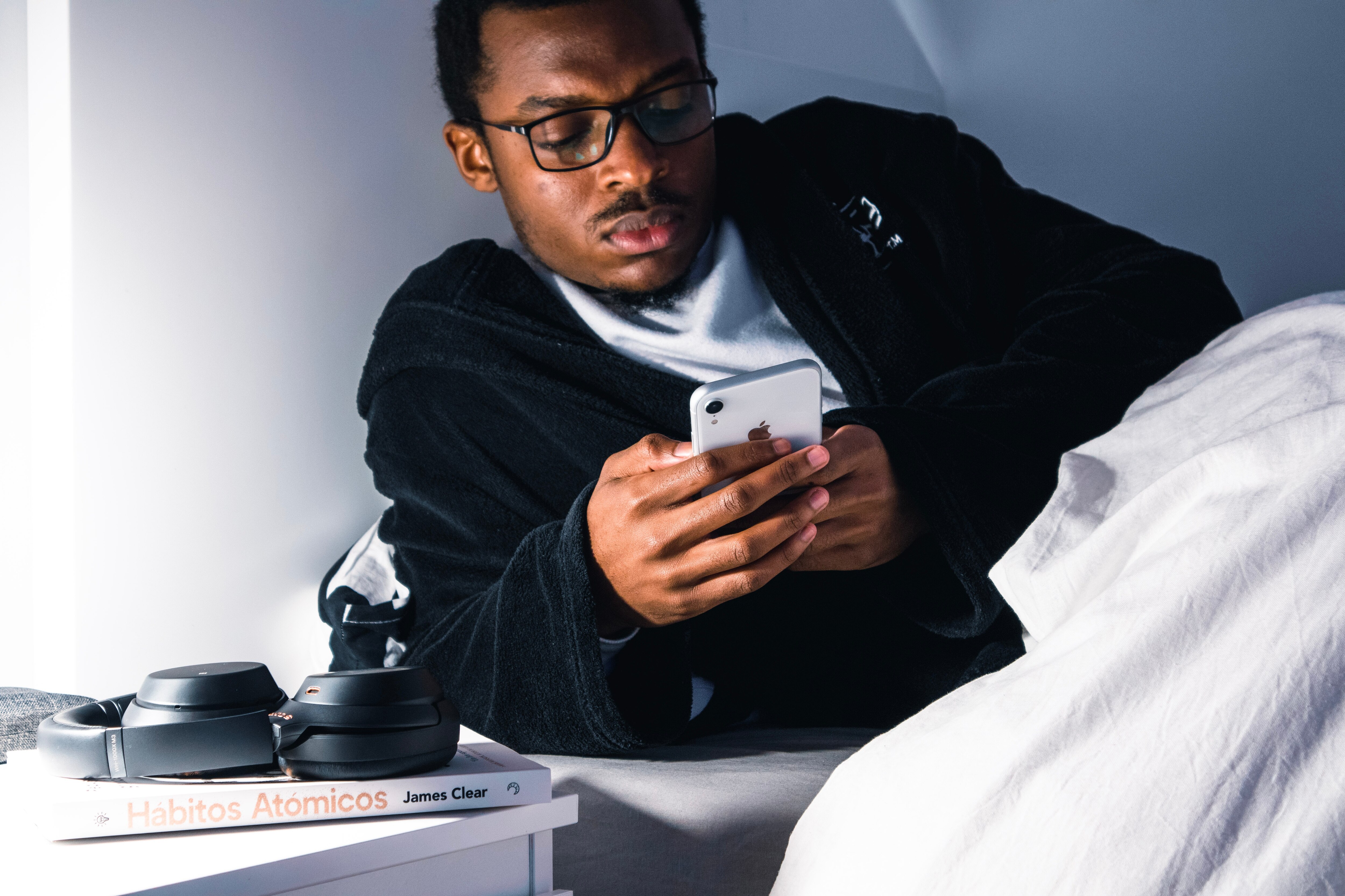 man using phone in bed