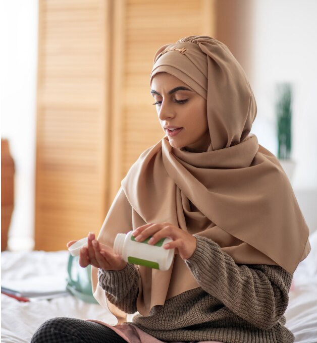 woman dispensing tablets