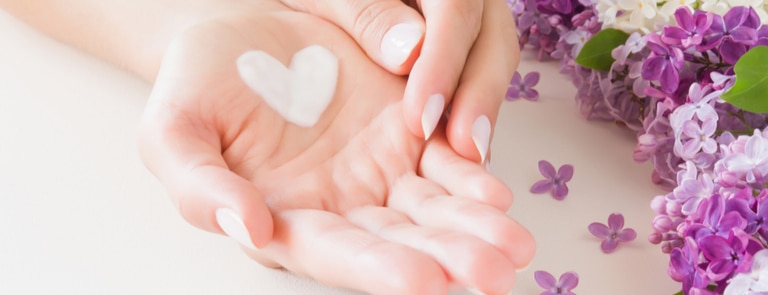 closeup of womans hands with heart shaped cream patch