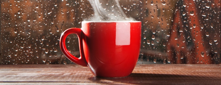 red mug of tea on windowsill
