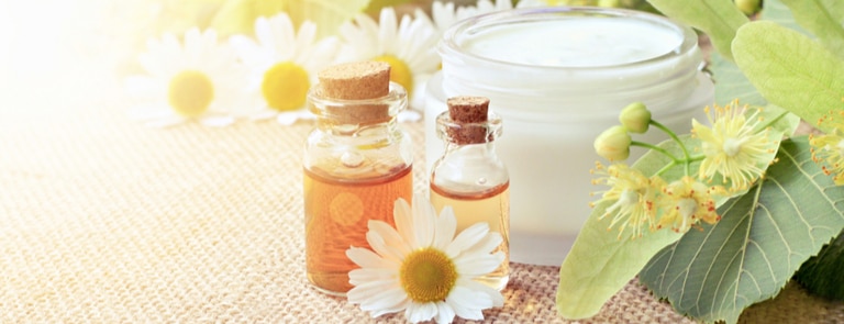 chamomile flowers with cosmetic bottle essential oil