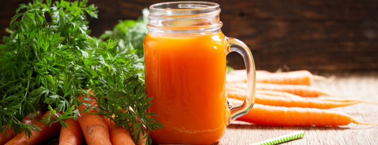 fresh mug of carrot juice with carrots