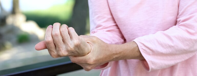 woman holding wrist joint pain