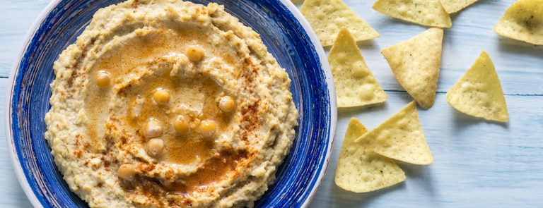 bowl of homemade hummus and tortilla chips
