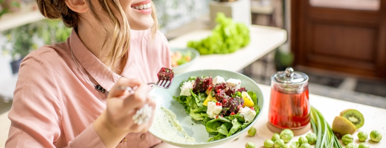 woman eating healthy keto salad