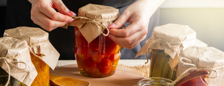 woman preparing pickle jars homemade