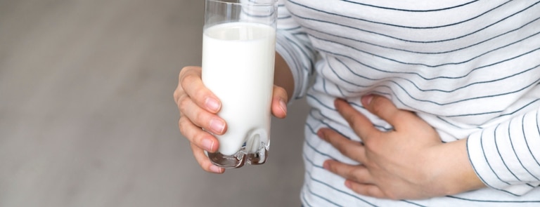 lactose intolerant woman holding her stomach