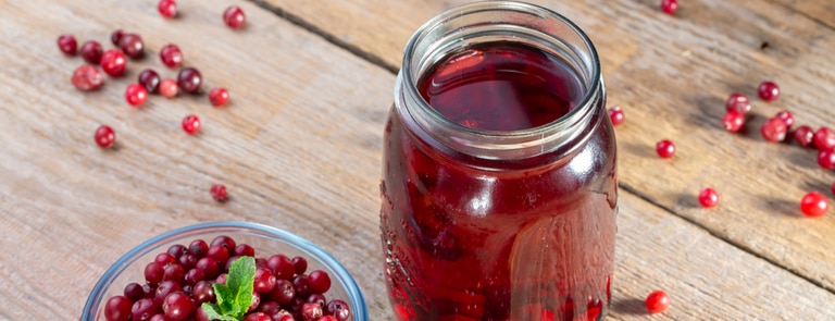 cranberry juice surrounded by cranberries