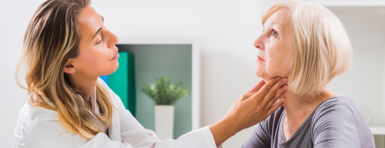 doctor examining woman's throat 