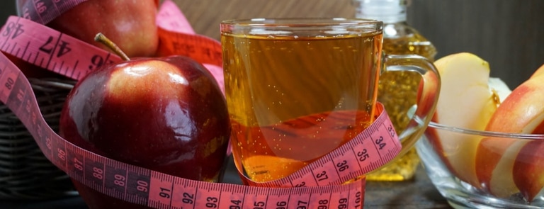 apple cider vinegar drink with tape measure 