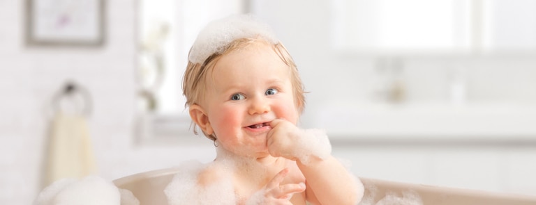baby in bath with soap