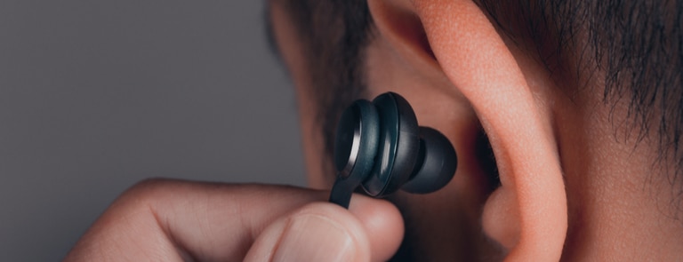 closeup of man putting earphones in ear