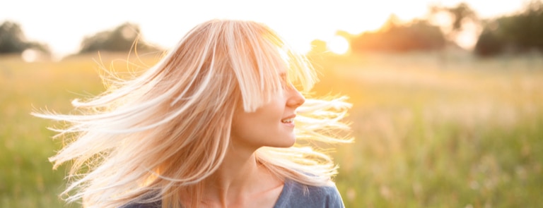 woman with light blond hair in sun