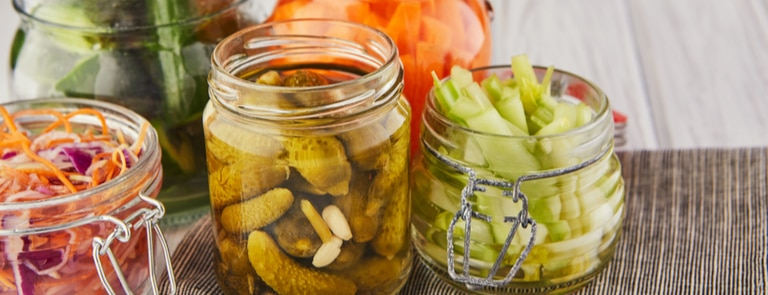 selection of fermented foods in jars for postbiotics