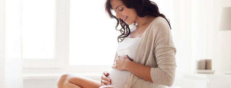 woman holding a baby bump