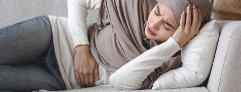 closeup of woman experiencing period pain 