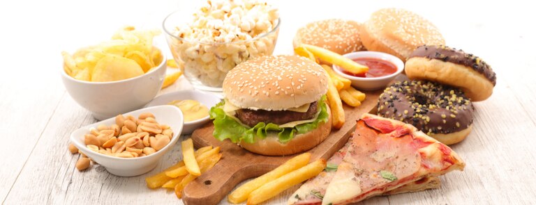 foods high in saturated fat burger, pizza, chips and doughnuts