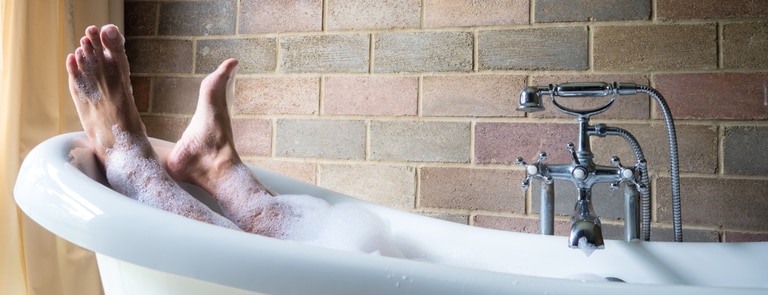 man in a bubble bath pampering himself