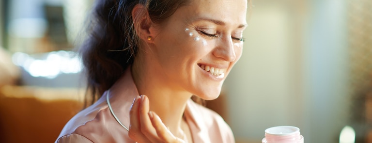 woman applying some vegan face cream 