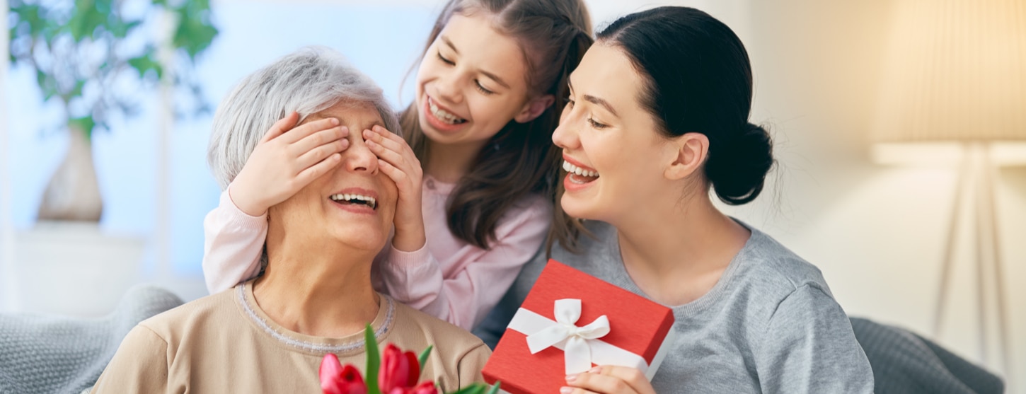 family giving gift to mum for mother's day