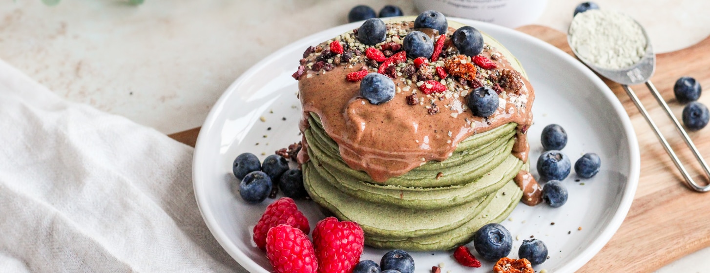 super green vegan pancakes made with Naturya SuperProtein powder topped with fresh fruit