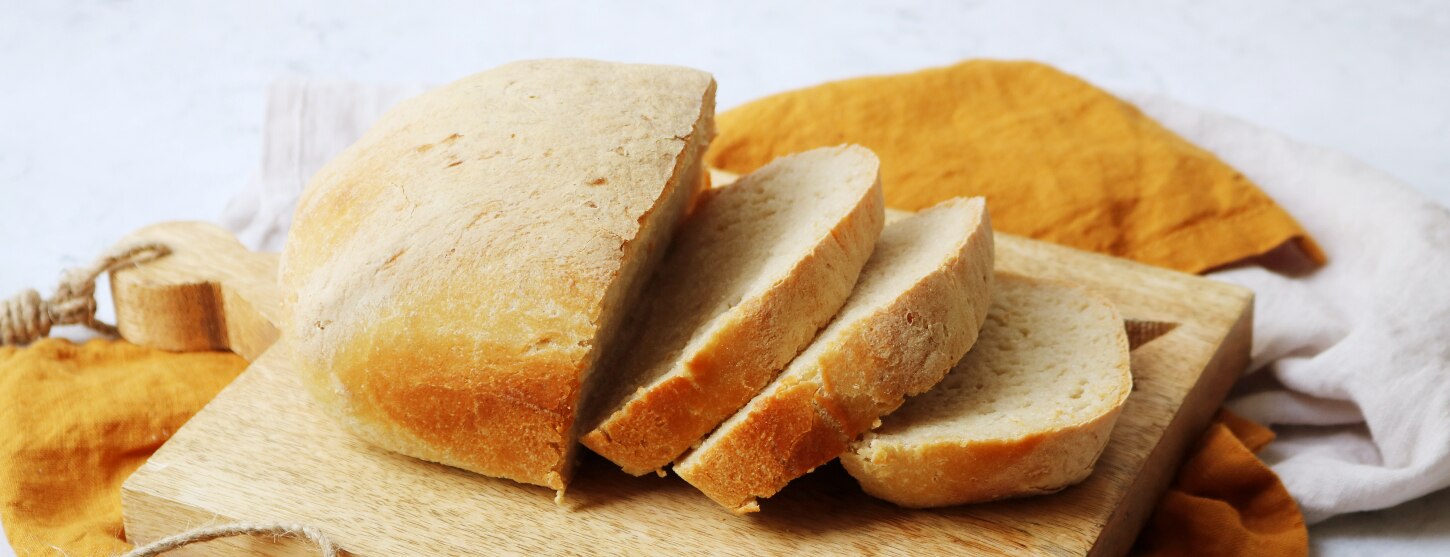 gluten free sandwich loaf sliced on a bread board