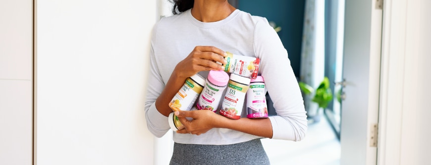 woman holding natures bounty vitamins
