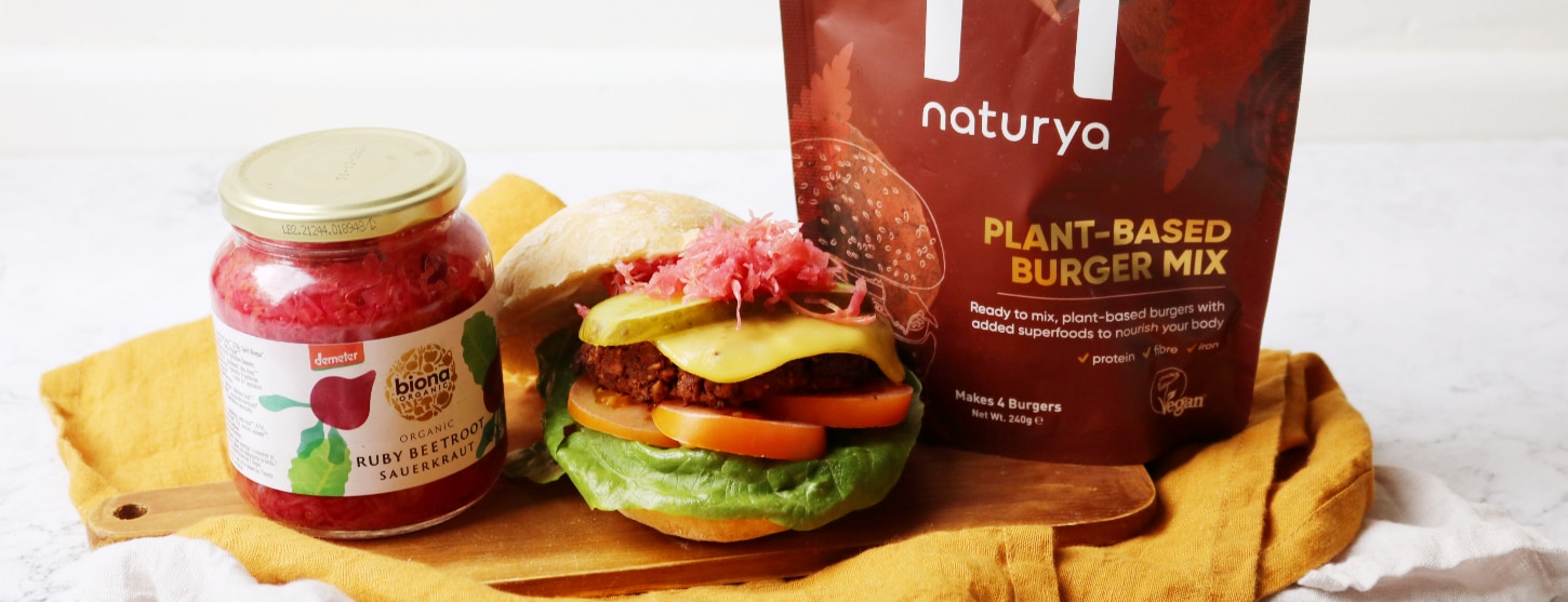 vegan plant-based burger next to pack of burger mix and jar of beetroot sauerkraut 