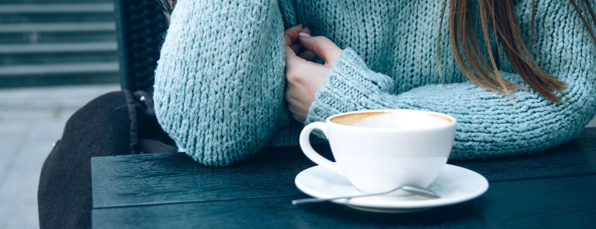 Blue Monday - Woman in blue jumper drinking coffee