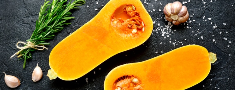 two halves of raw butternut squash sliced open