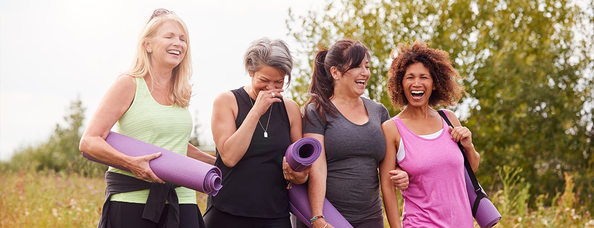 ladies walking in the park with yoga mat