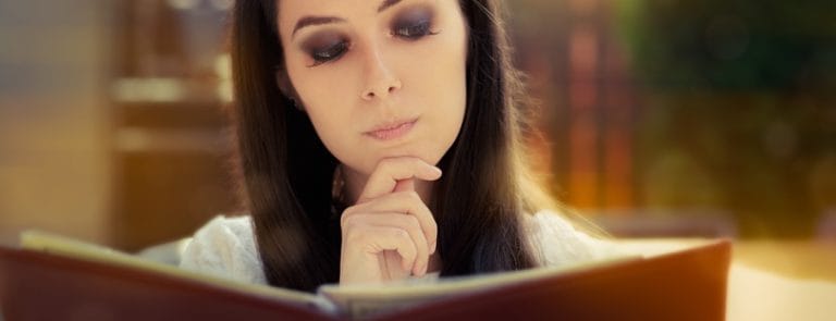 A women reading a book and pondering