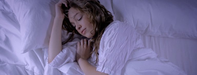 A women asleep in a bed