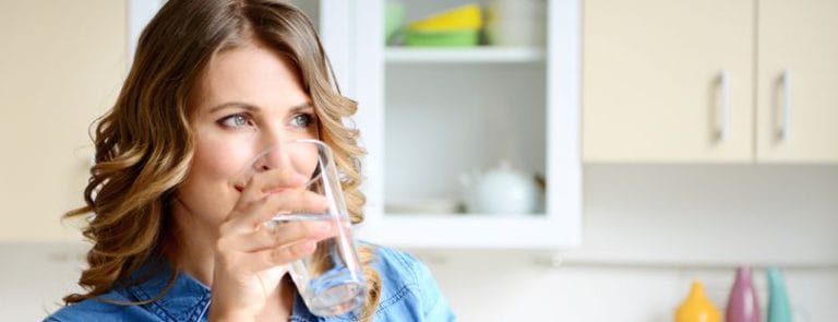 A women drinking a glass of water