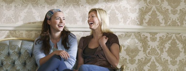 Two Women Laughing on a Chair