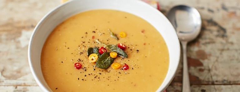 A bowl of pumpkin and parsnip soup with sage and chilli