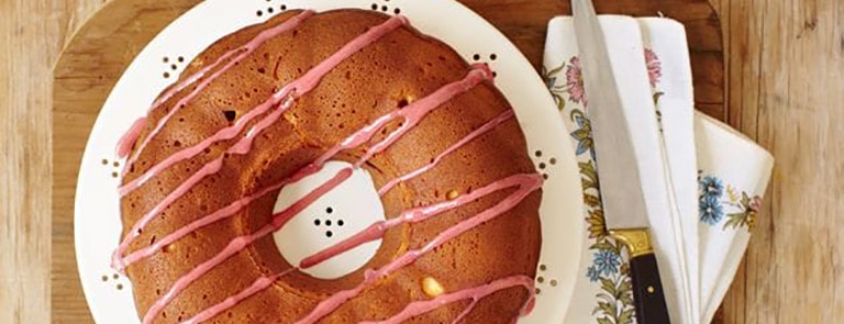 A vanilla bundt cake with berry coulis