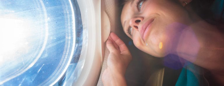A women looking out of the window of an airplane
