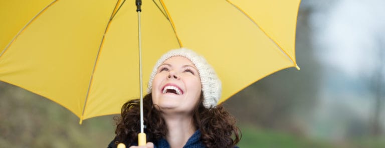 Woman holding yellow umbrella