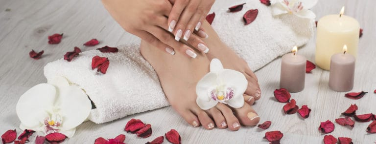 female feet and hands with french manicure
