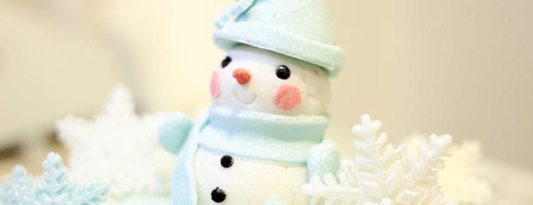 Snowman decorated with a Hat and blue scarf