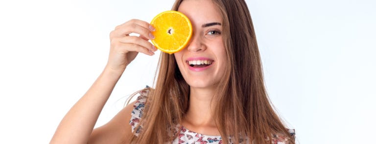 girl with orange slices in hands