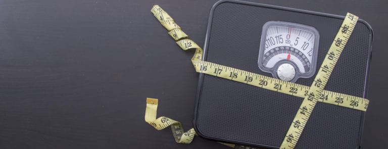 Tape measure wrapped around scales