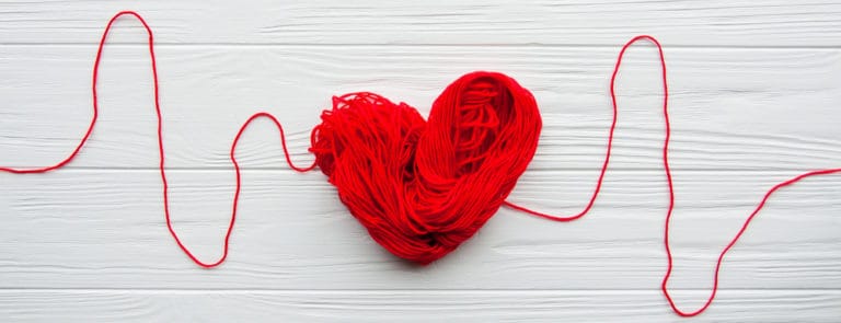 Abstract red heart. Problems with heart. Heart and cardiogram is made of red thread.
