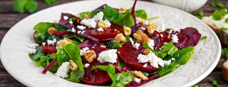 Healthy Beet Salad with fresh sweet baby spinach, kale lettuce, nuts, feta cheese and toast melted