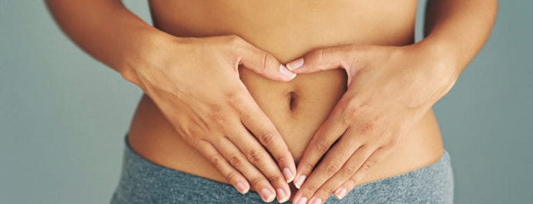 Woman with her hands on her stomach