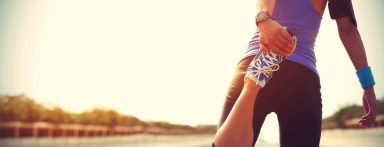 Woman outside stretching legs for excercise