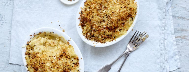 Two portions of macaroni cheese with a chilli and garlic crumb topping