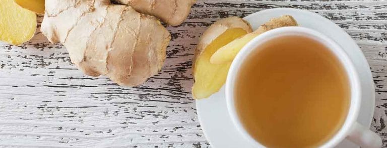 Ginger and teacup on a wooden surface